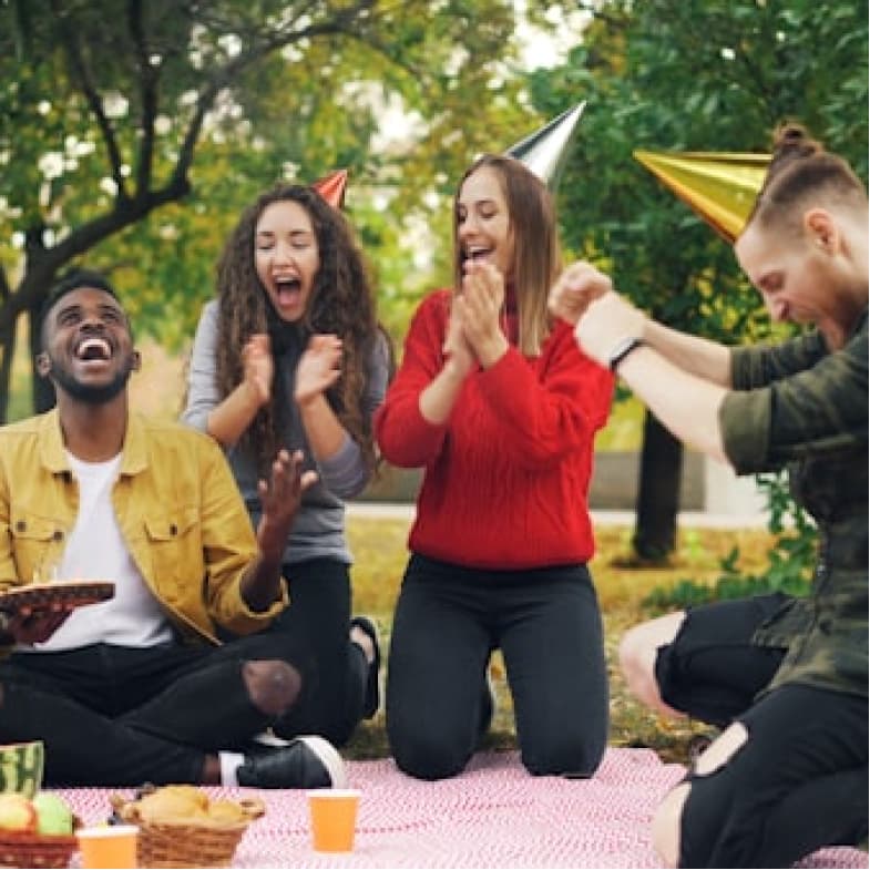 Friends celebrating birthday outdoors