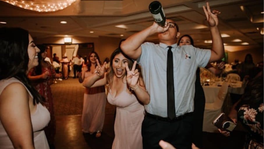 People at a wedding reception using mobile phones