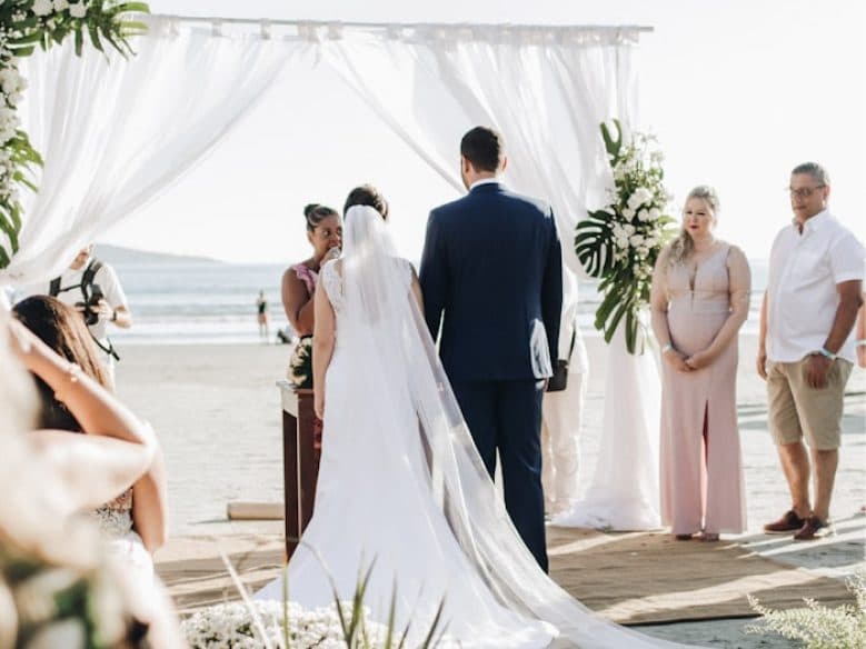 Newly wed couple on the aisle at a beach ceremony