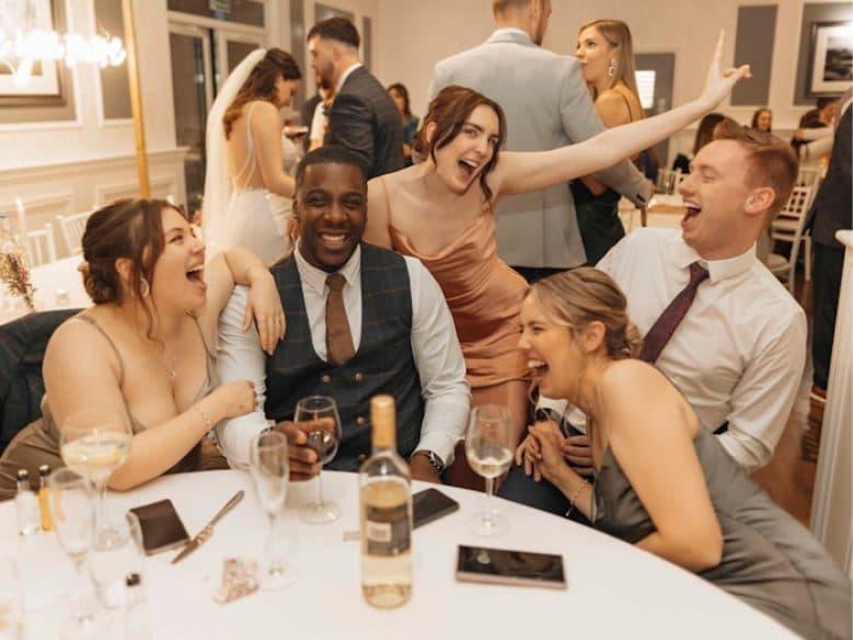 Family gathering around a reception table at a wedding