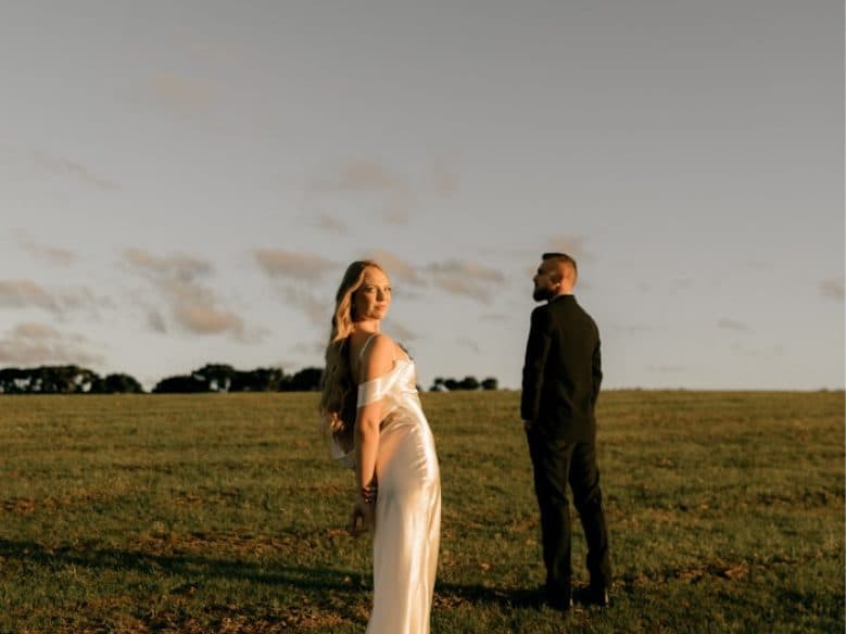Elegant couple standing in golden hour sunlight