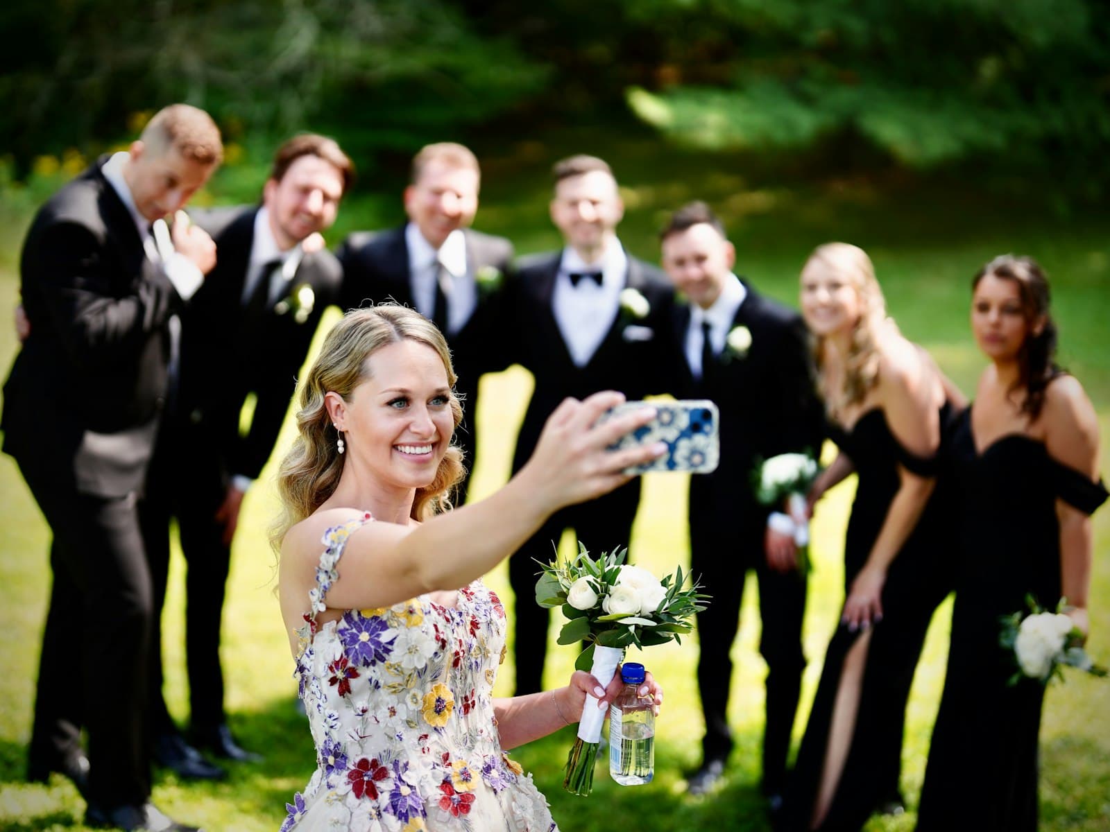 A wedding party taking a group photo together