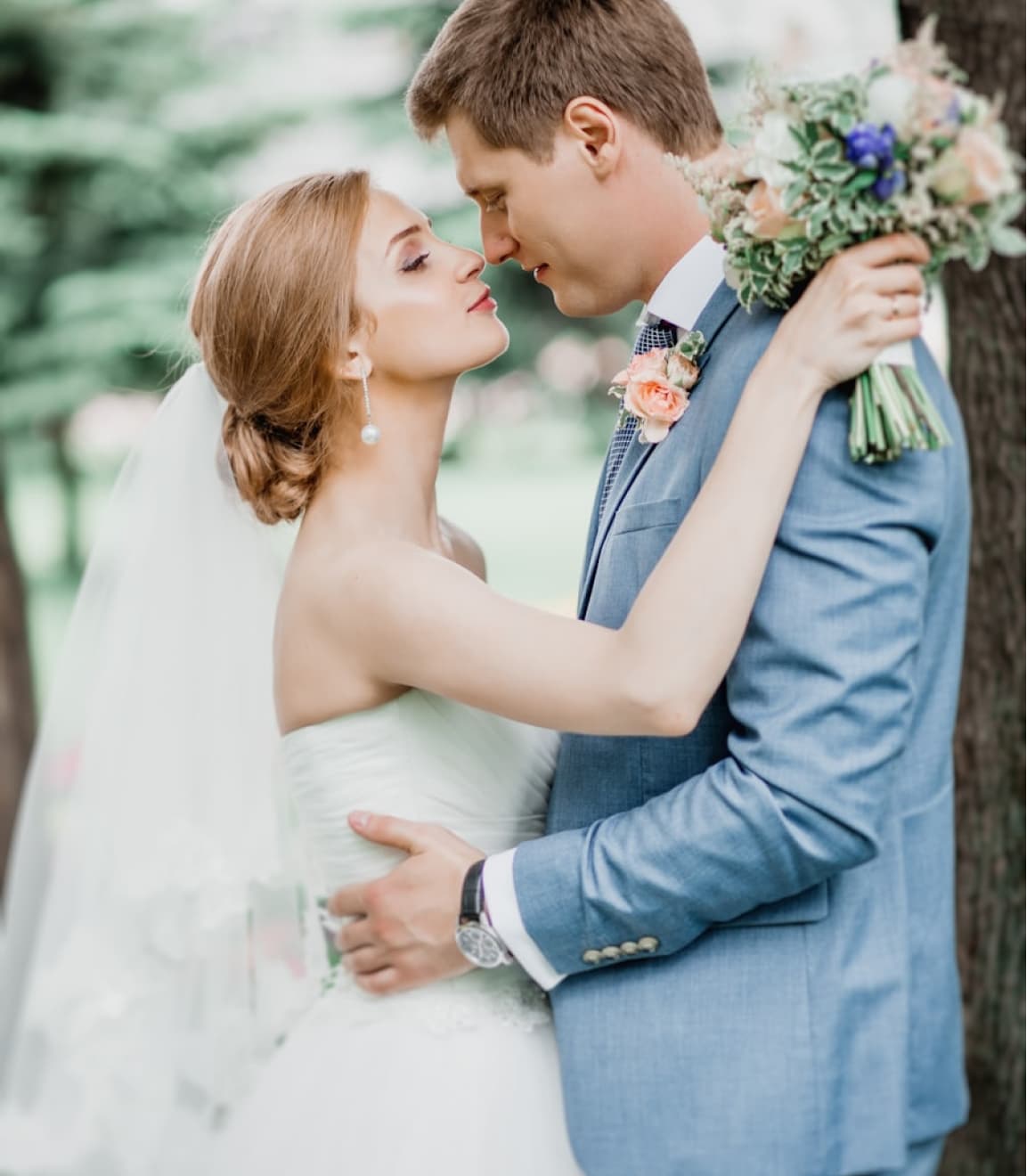 Wedding couple sharing a tender kiss